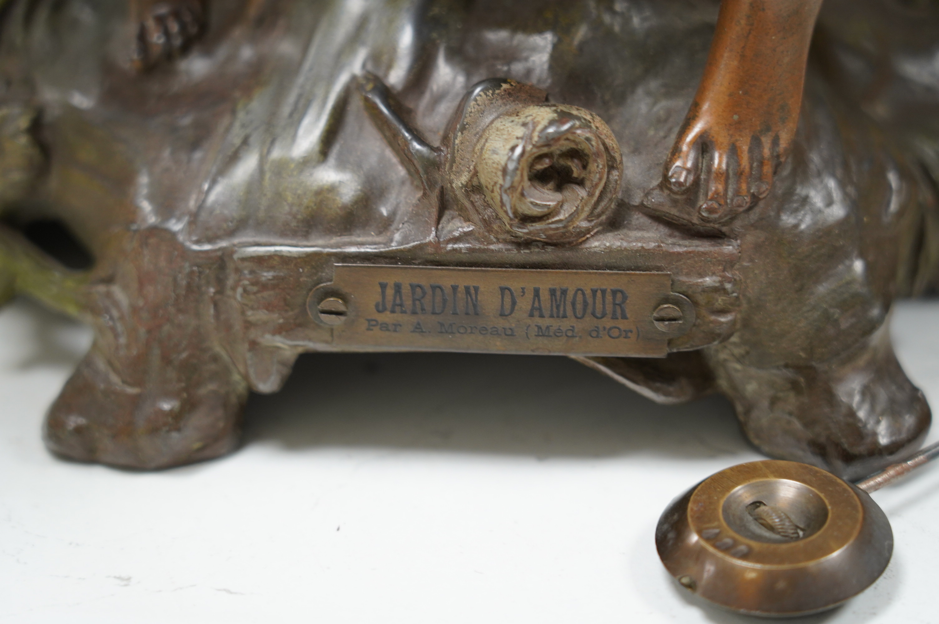 A French Art Nouveau spelter patinated figural table clock, ‘Jardin D’Amour’, with a late 19th century movement striking on a bell, height 53cm. Condition - good